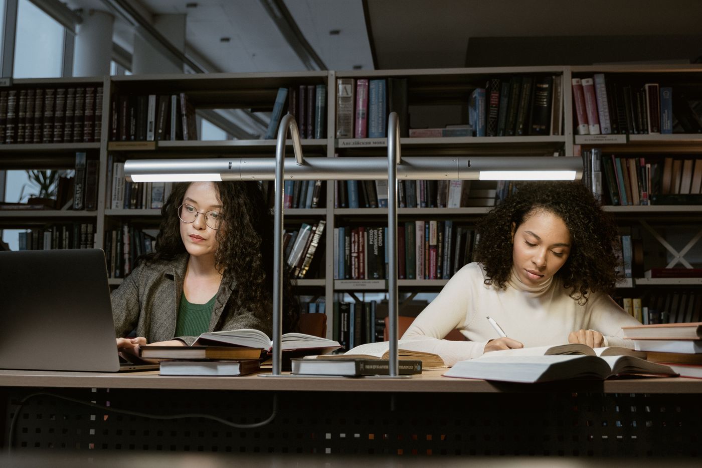 College students studying with books in a university library